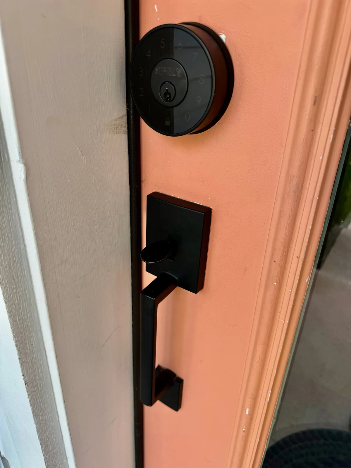 A smart lock on the front door, showing modern security features and an inviting entrance, symbolizing peace of mind and easy access for business and group travelers.